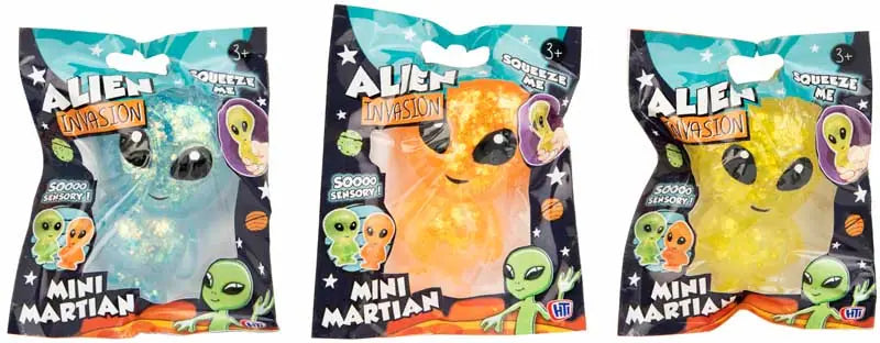 Blue, orange and yellow glitter Mini Martian squeeze toys side by side in packaging