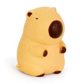 The Big Squij Capybara slow-rise squishy toy — a large yellow-orange capybara-shaped squishy with dark brown muzzle, ears, and feet, shown from the side against a white background