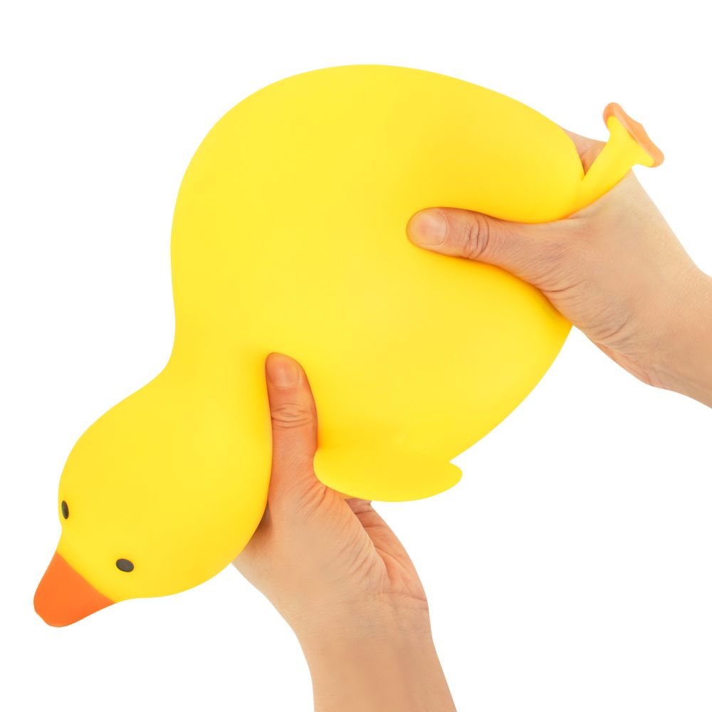 Two hands squeezing the soft yellow Big Squij Duck squishy toy to show its texture