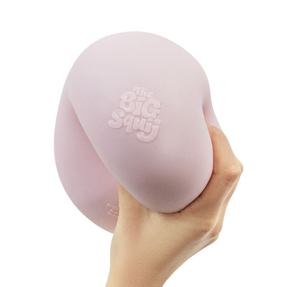 Hand squeezing the soft pink Big Squij Marshmallow squishy toy to show its texture