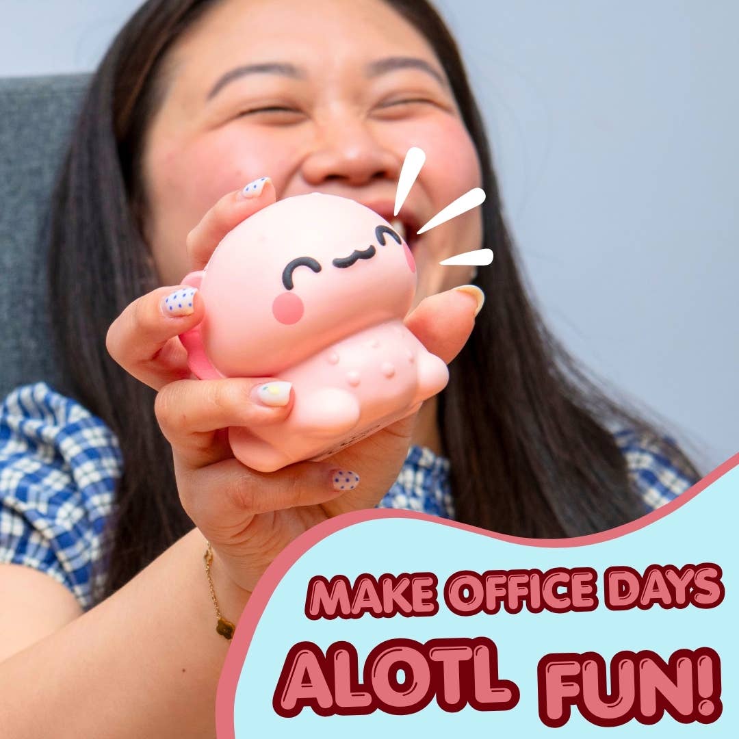 A woman holding a pink squishy toy with a cute cartoon face, with a text overlay that reads 'MAKE OFFICE DAYS AOTL FUN!'.