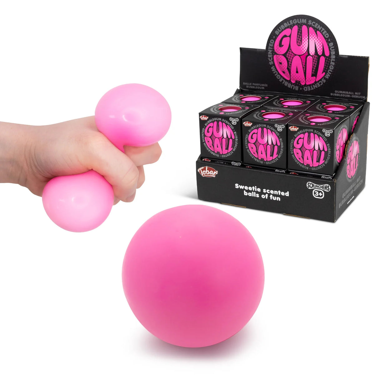 Pink bubblegum squish ball being squeezed alongside product display box and loose ball