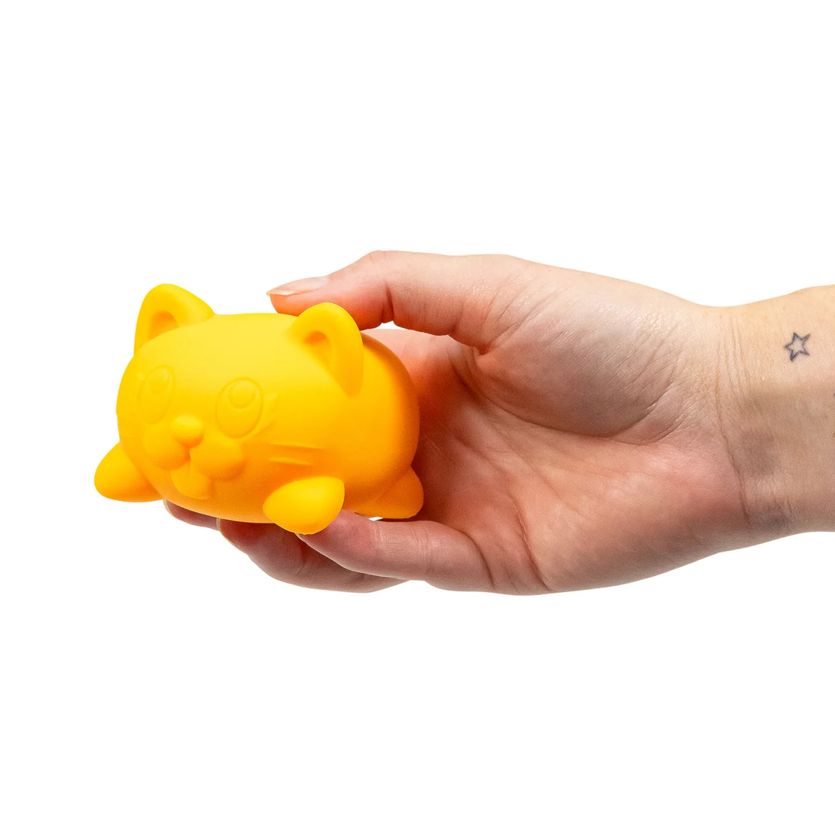 Hand holding an orange Candy Cats scented squishy stress toy to show palm-sized scale