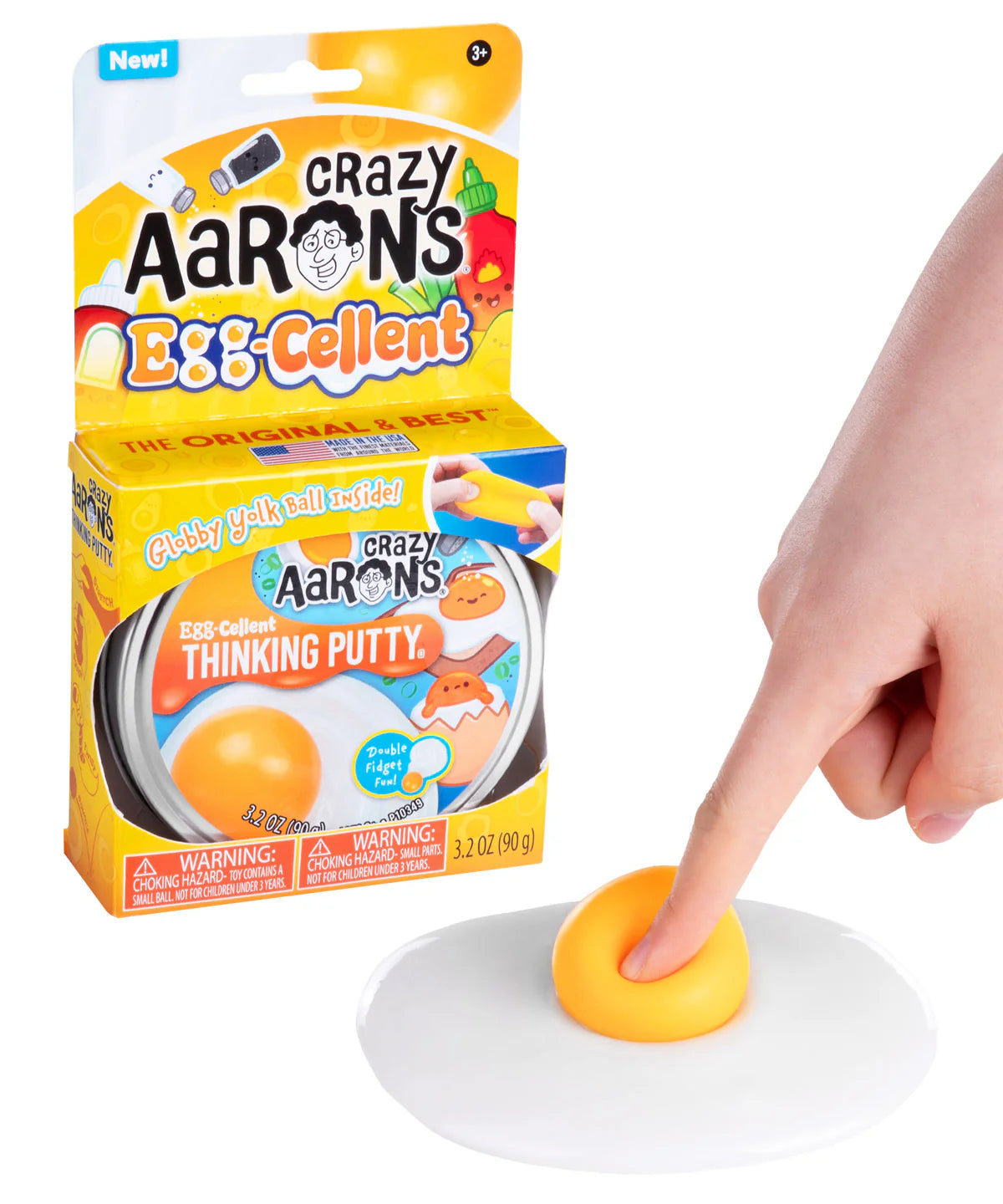 Crazy Aaron's Egg-Cellent Thinking Putty shown in packaging alongside white putty spread flat with orange yolk ball, finger pressing into it