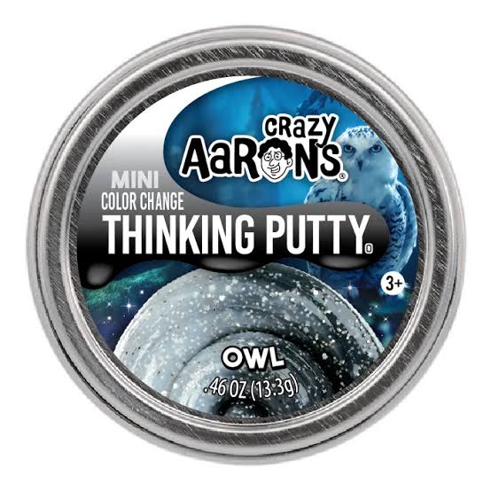 A round metal tin of Crazy Aarons Mini Color Change Thinking Putty in the Owl flavor, featuring a blue and black space-themed label with an owl graphic.