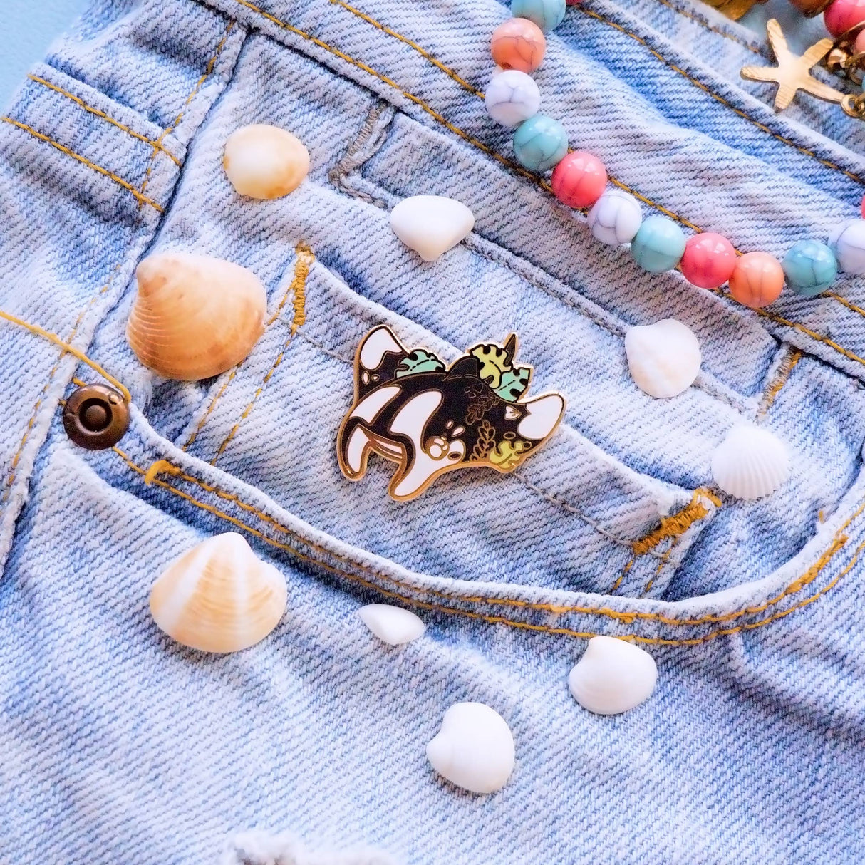 Evy Benita Oceanic Manta Ray enamel pin worn on denim jacket pocket