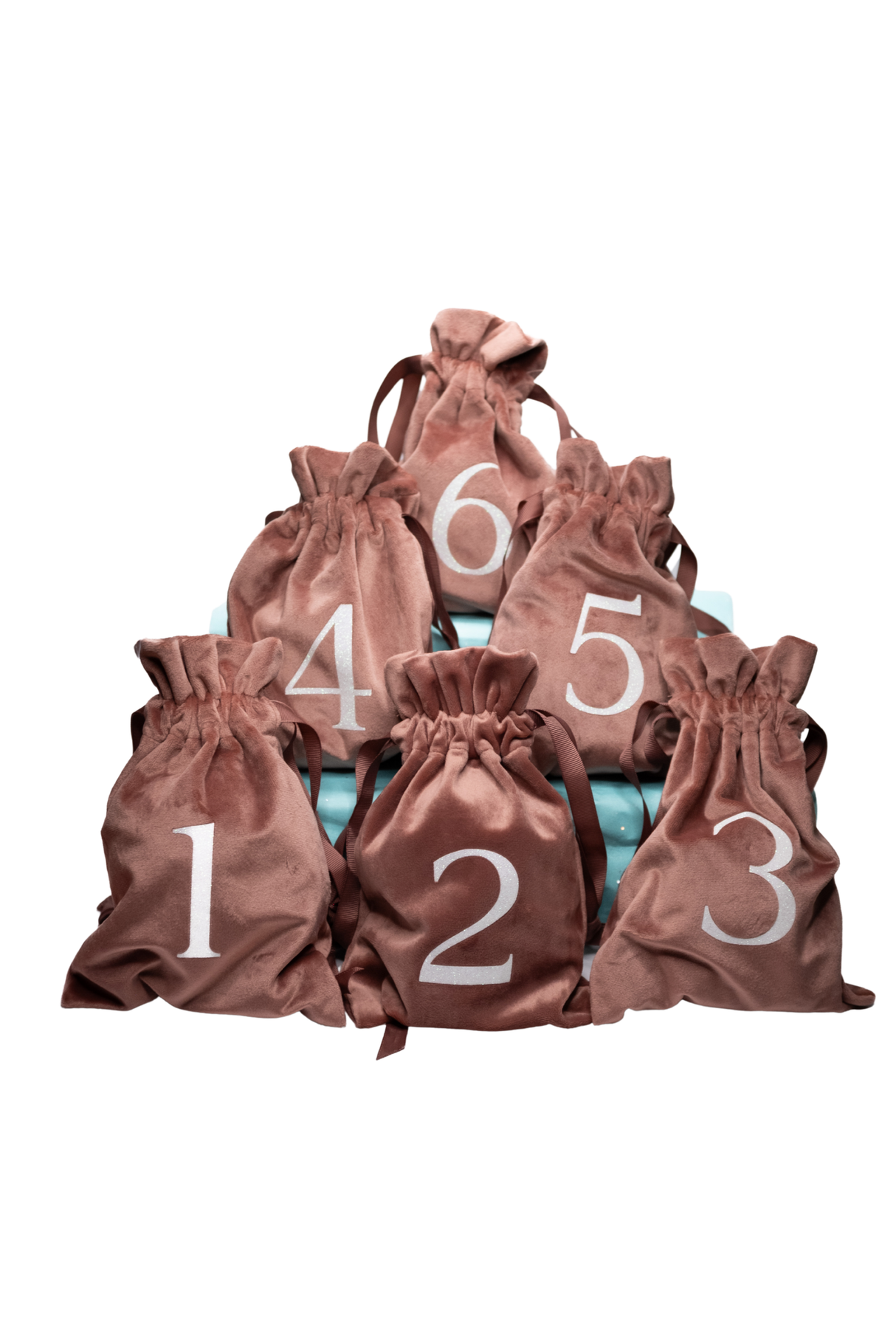 Fidget Fables Mystery Palm Pals six numbered blush velvet drawstring bags stacked