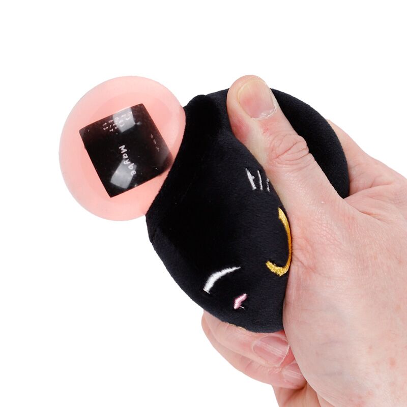 Hand squeezing Fortune Squeezies Lucky the Black Cat magic fortune teller plush squeezy toy with pink magic ball showing maybe answer on fortune dice
