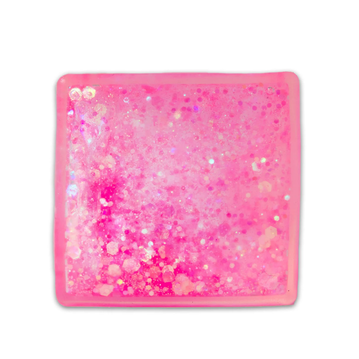 Pink glitter sugar cube from above showing iridescent glitter and soft gel texture