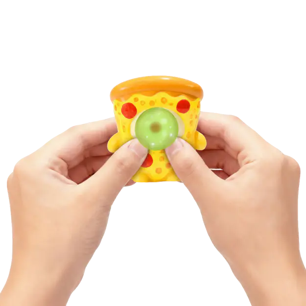 Hands squeezing a pizza Gum Gums mini figure as it blows a green bubble