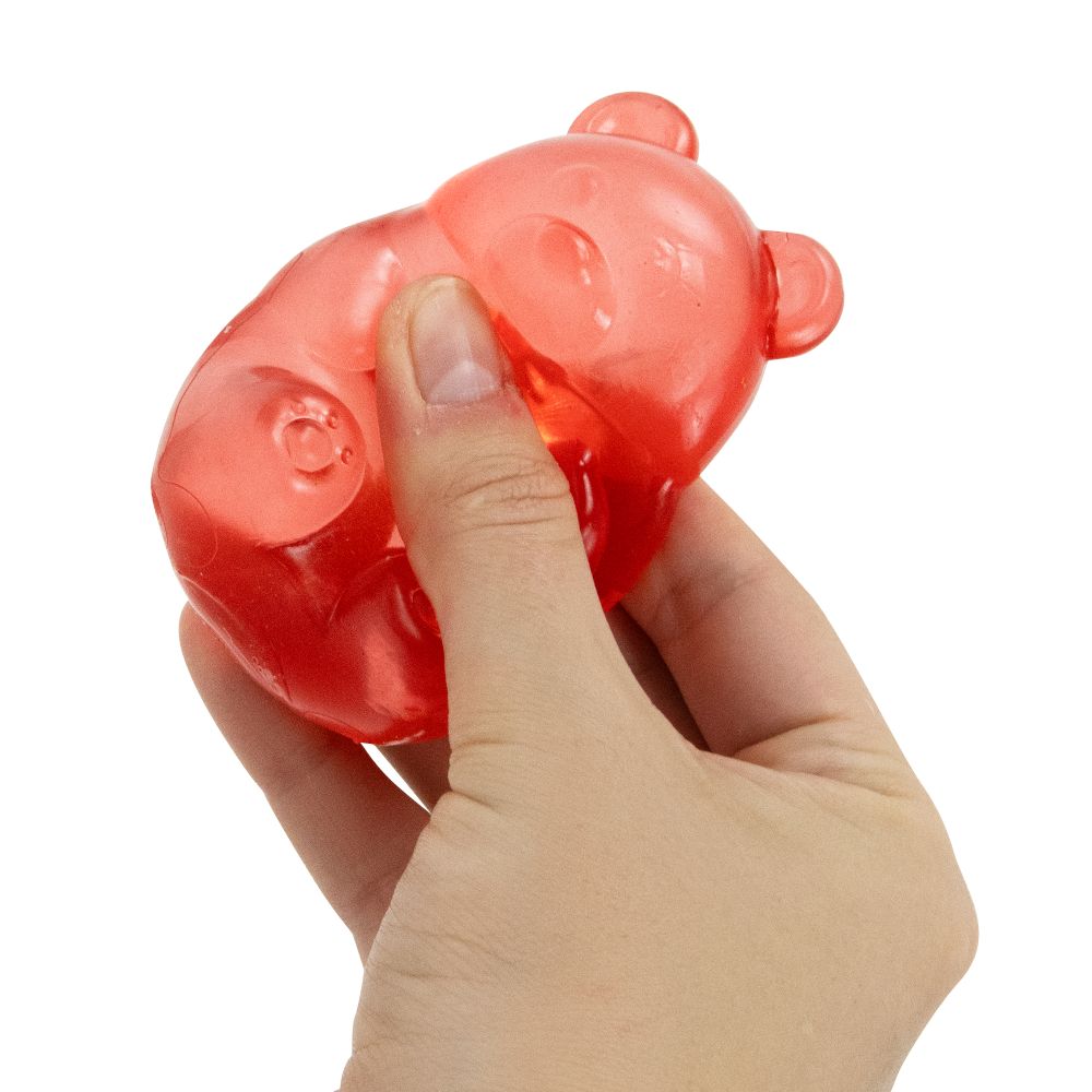 Red gummy bear squishy toy being squeezed in hand, soft translucent sensory fidget toy