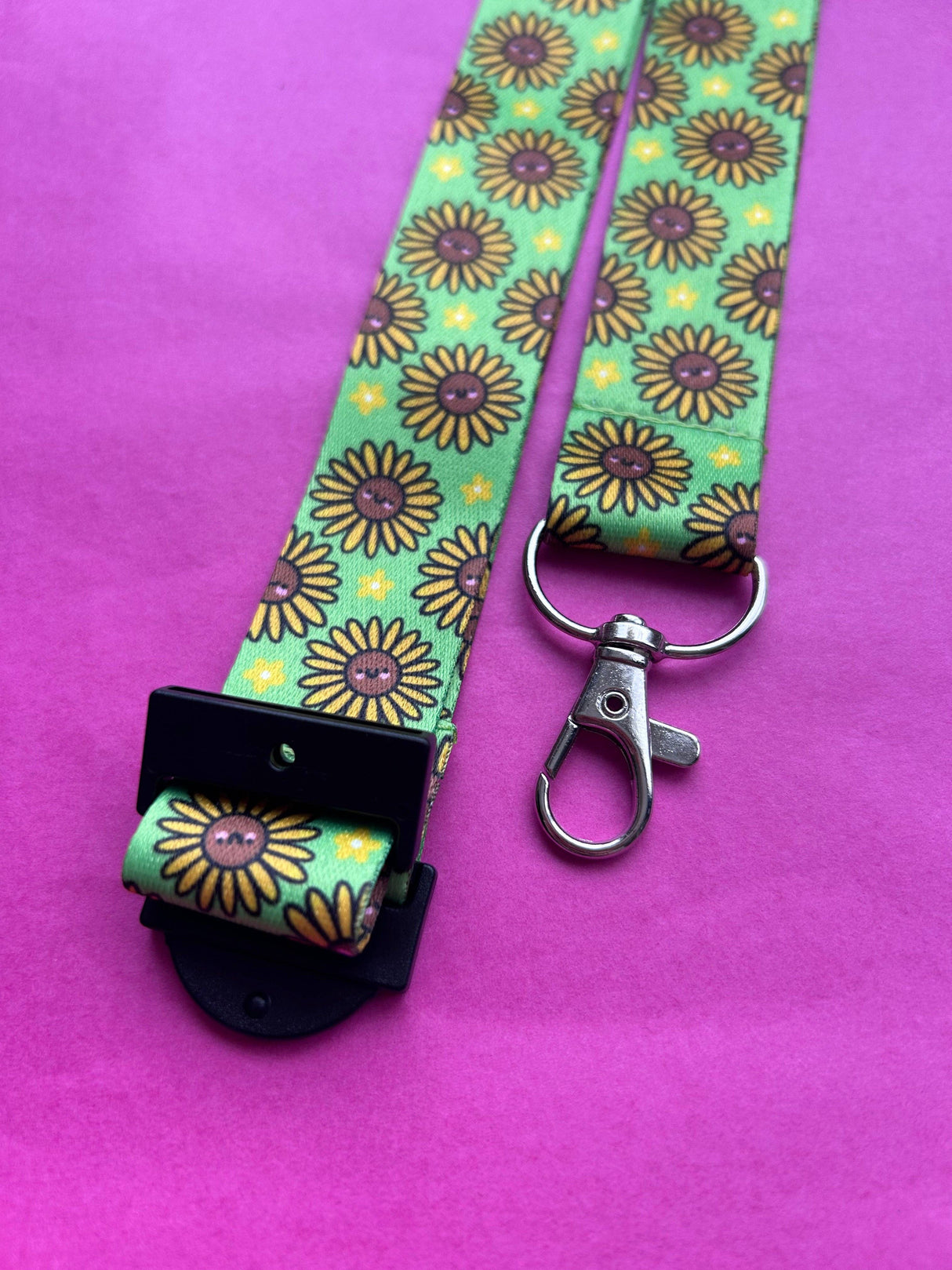 Happy Sunflowers kawaii lanyard laid flat on a pink background showing full length, breakaway clasp and metal swivel clip