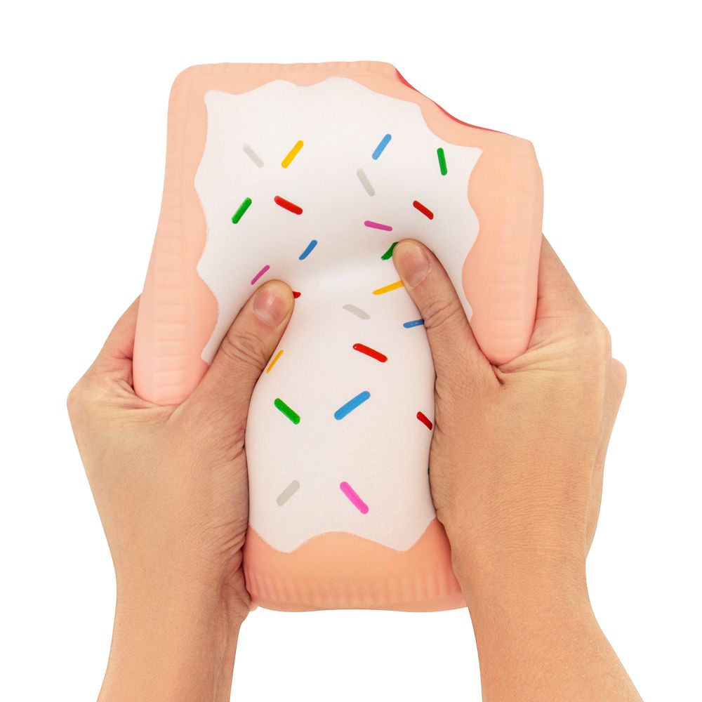 Two hands squeezing a jumbo pink peach squishy Pop-Tart with white icing and rainbow sprinkles