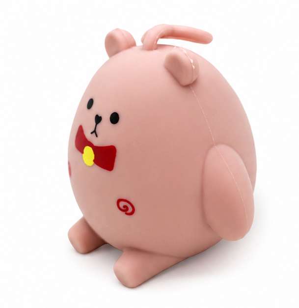 Blush pink kawaii bear squishy toy with red bow, sensory fidget toy