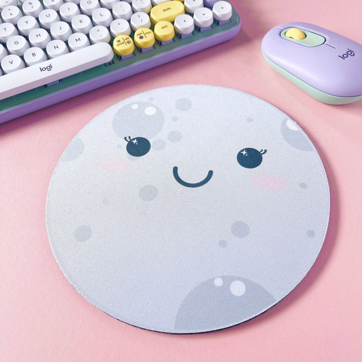Round kawaii moon face mouse pad, grey and white, cute desk accessory on pink background