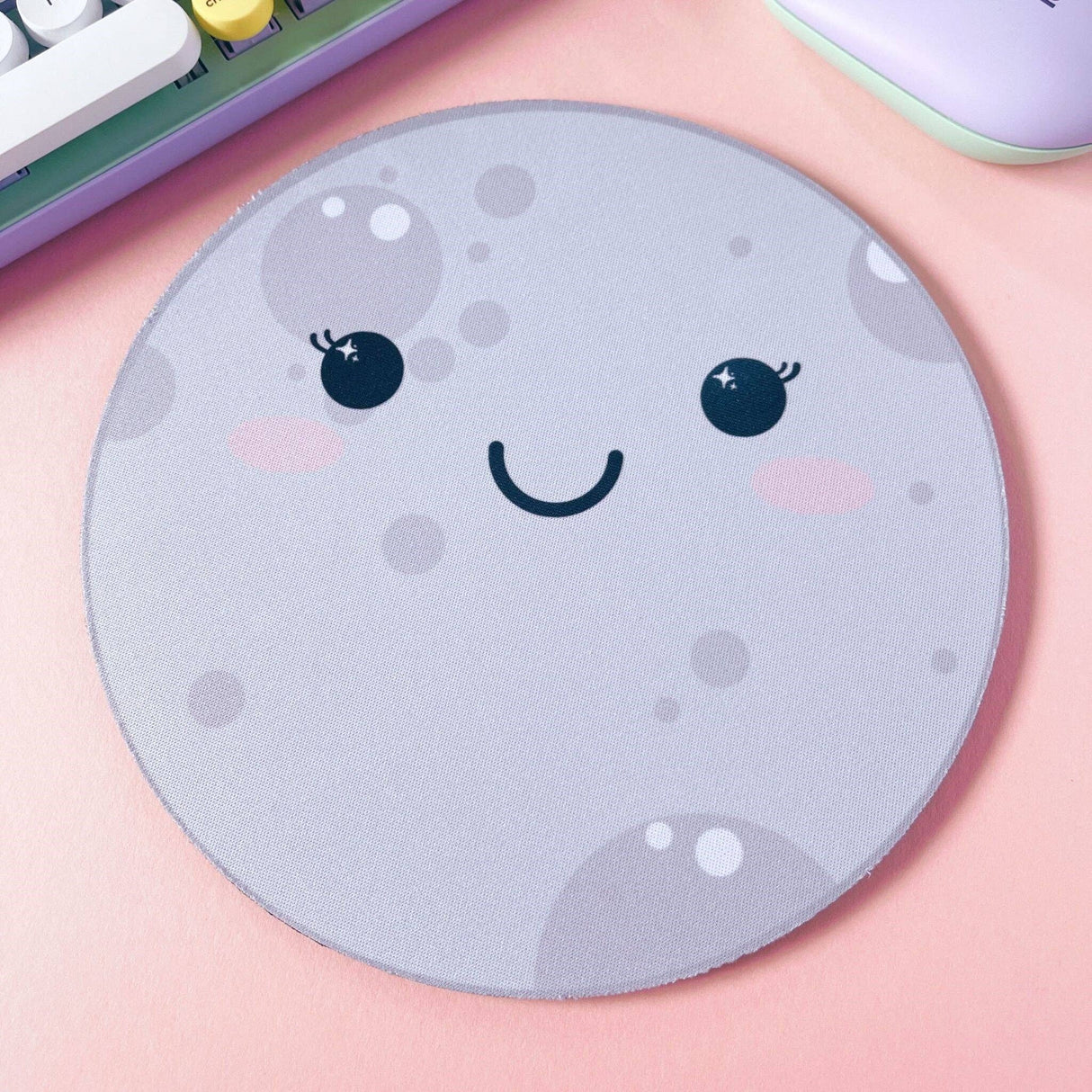 Kawaii moon mouse pad angled view showing rubber base, grey round desk pad