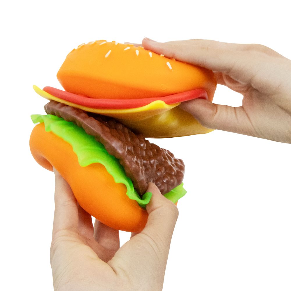Two hands pulling apart the layers of a Keycraft Big Squij Peel 'N Stack Burger squishy toy
