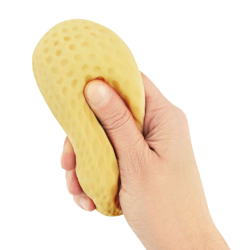 Hand squeezing Keycraft Crunchy Peanut sand-filled stress relief toy showing tactile texture and flexibility