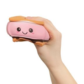 Hand squeezing pink strawberry Keycraft Squeeze S'mores slow-rise squishy toy