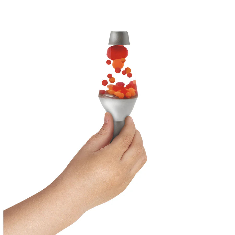 Hand holding Lava Brand Squish N Flow showing red and orange globs flowing upward when squeezed