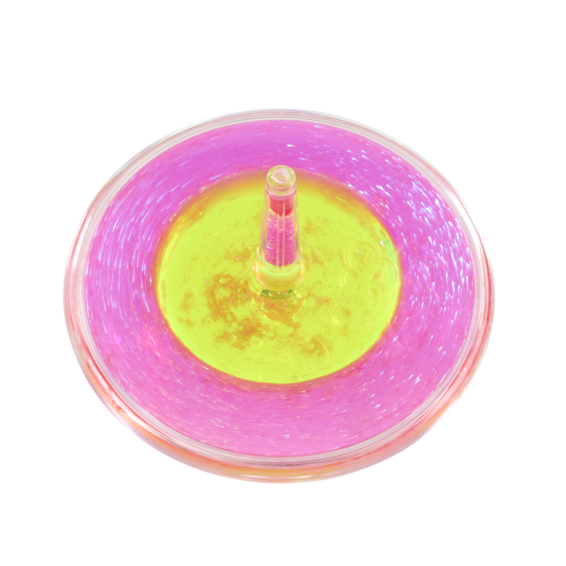 Close-up overhead view of pink and yellow Lava Storm liquid spinner in motion on black surface