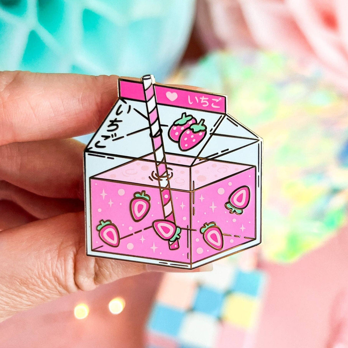 Lula Rocks Strawberry Milk kawaii enamel pin, pink ichigo carton, hand-held close-up