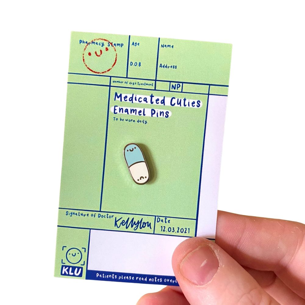 Medicated Cuties Enamel Pins on a green card in a white background