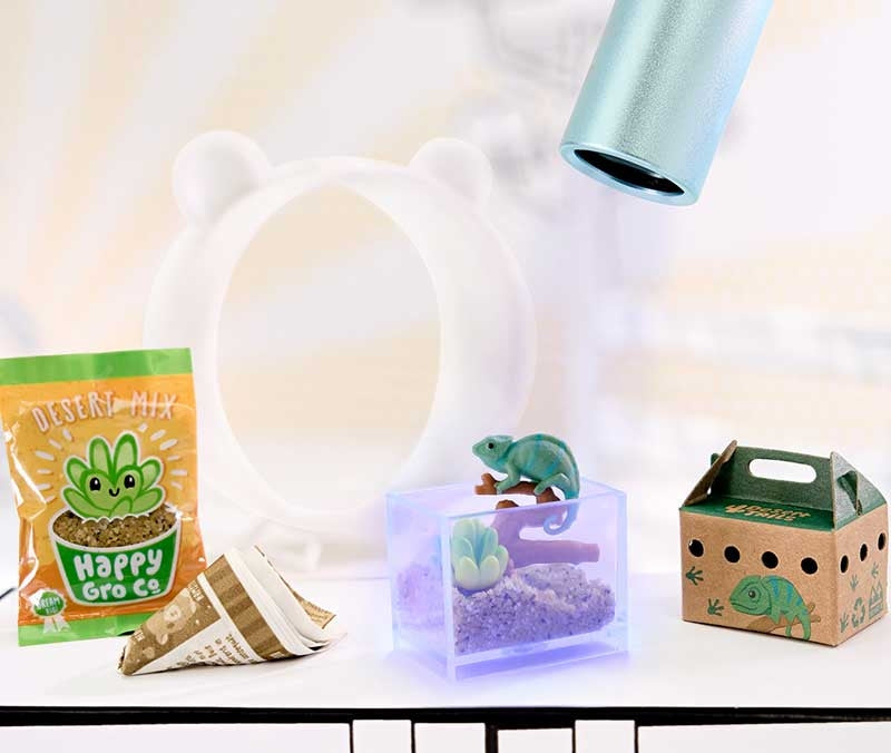 MGA Miniverse Make It Mini Animals completed chameleon terrarium scene displayed under UV light with desert accessories