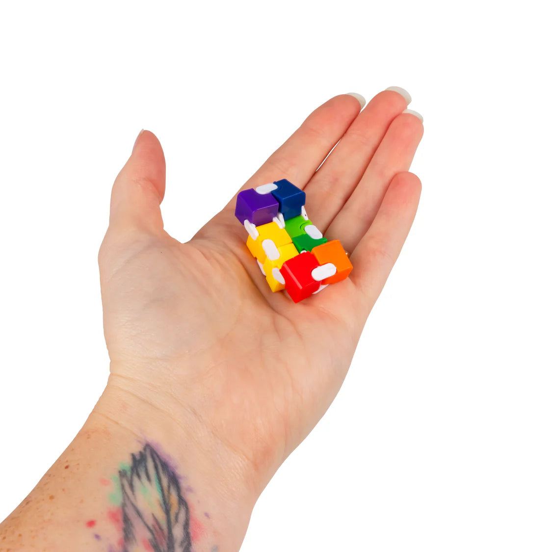 Adult hand displaying a small rainbow infinity cube fidget toy