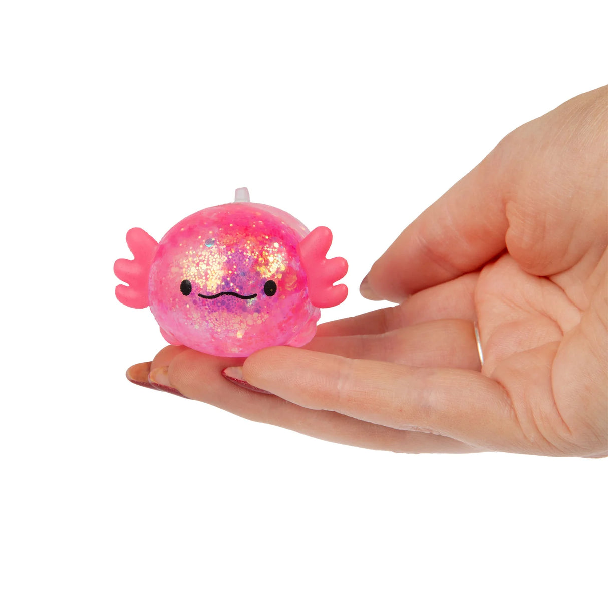 Pink glitter gel axolotl squishy resting in an open palm showing size and detail