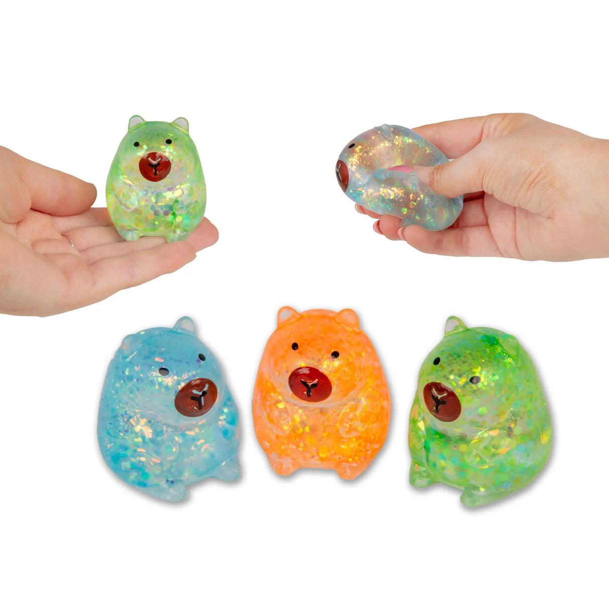 Two hands holding and squeezing glitter gel capybara squishies with blue, orange and green capybaras displayed below