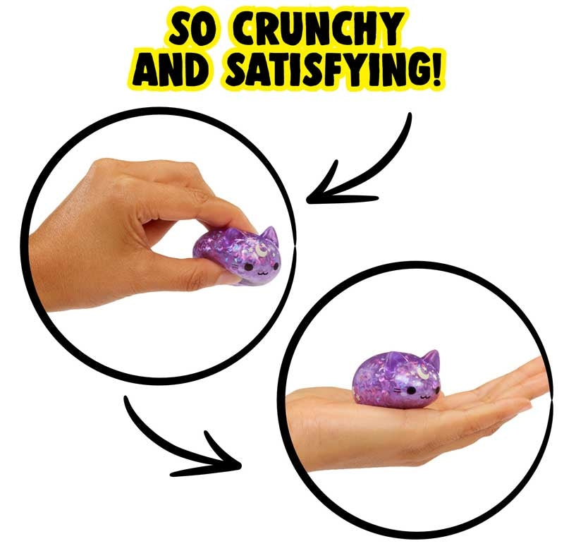 Hand squeezing and holding a small purple glitter kawaii cat Moj Moj crunch squishy toy