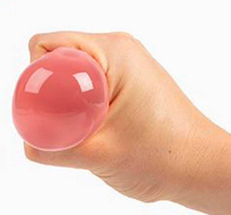 Hand squeezing pink Mushy Brain squishy stress relief sensory fidget toy showing texture and squeeze