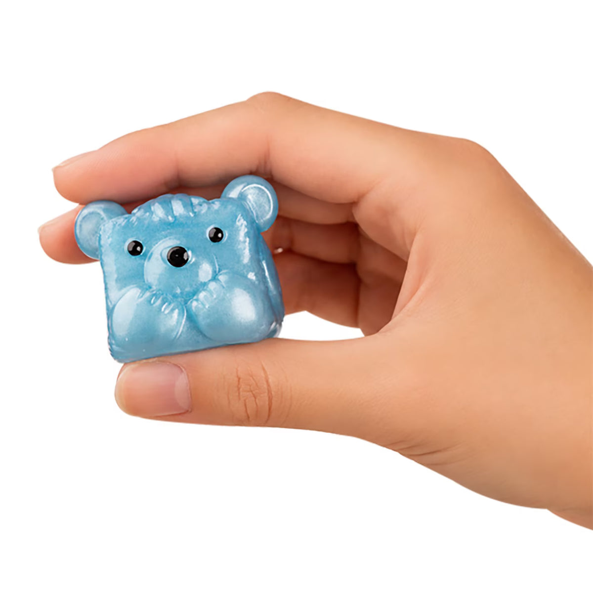 A hand holding a small, translucent light blue bear-shaped squishy toy against a plain white background.
