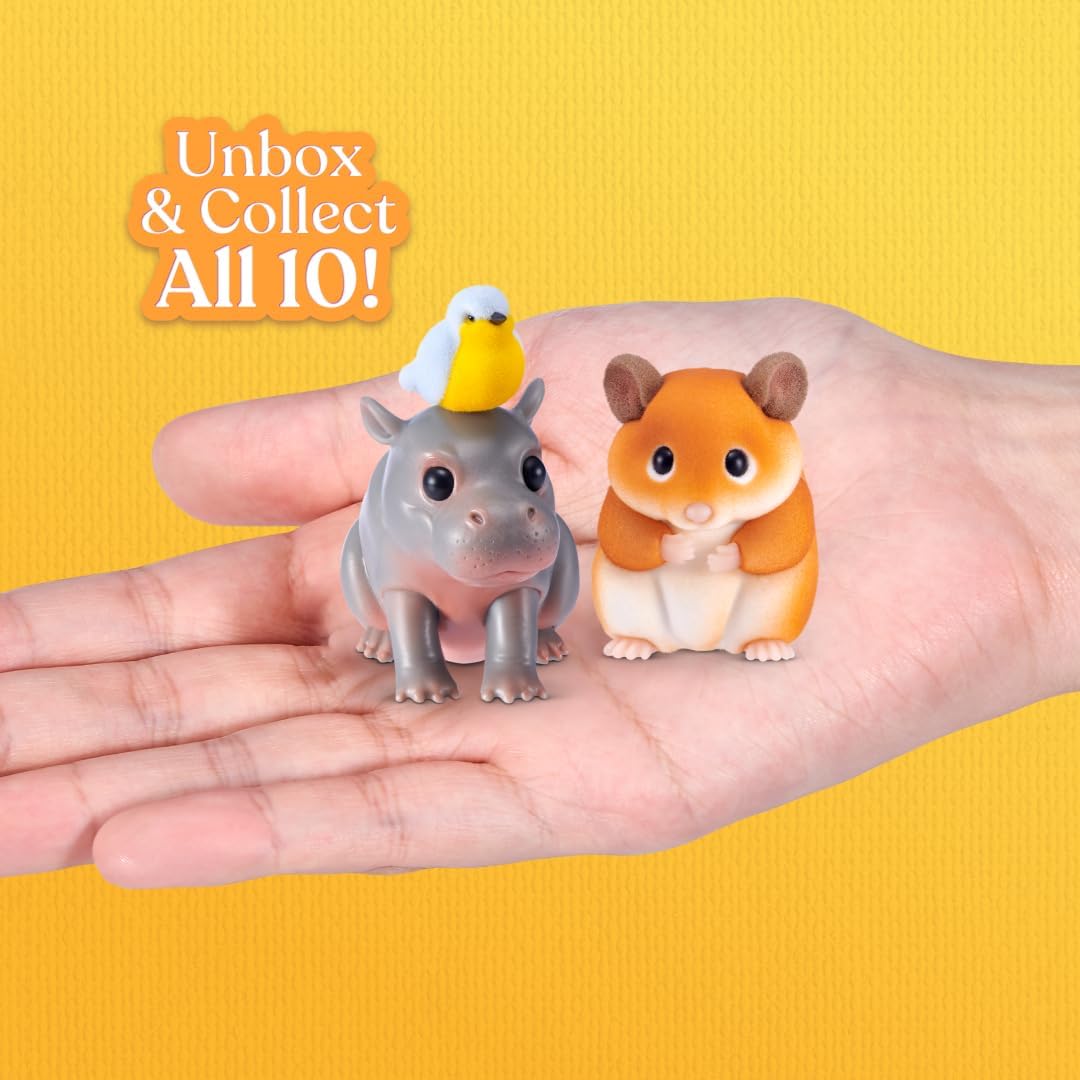 Hand holding My Mini Pets miniature hippo with yellow bird and flocked hamster figures