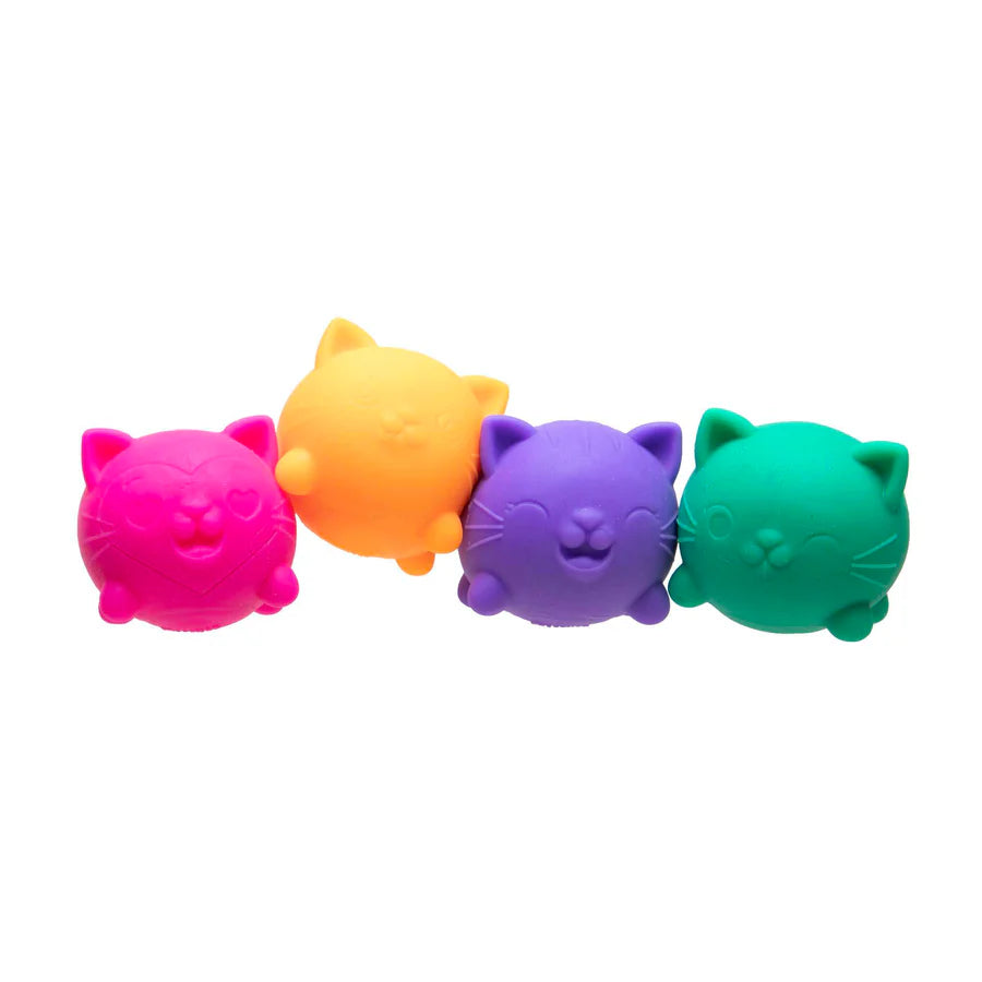 All four Nee Doh Cool Cat squishies lined up in a row on a white background