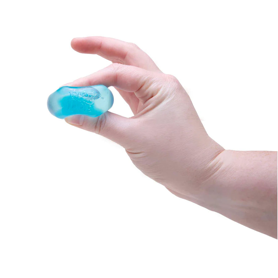 Hand squeezing a translucent blue Nee Doh Nice Ice Baby squishy cube between fingers
