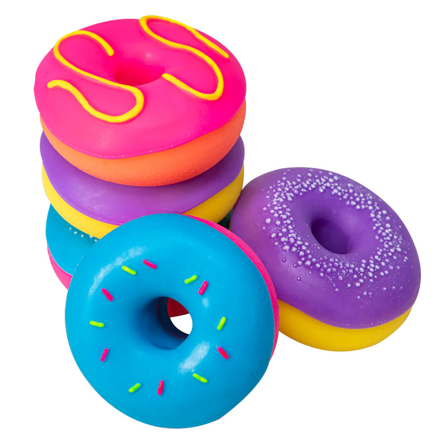 Four NeeDoh Dohnut squishy toys in pink, purple, blue and orange arranged in a stack and loose