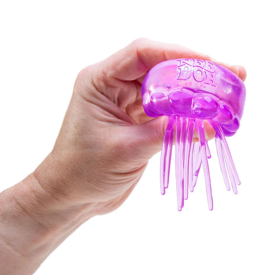 Hand squeezing purple NeeDoh Jelly Squish jellyfish fidget toy in a fist