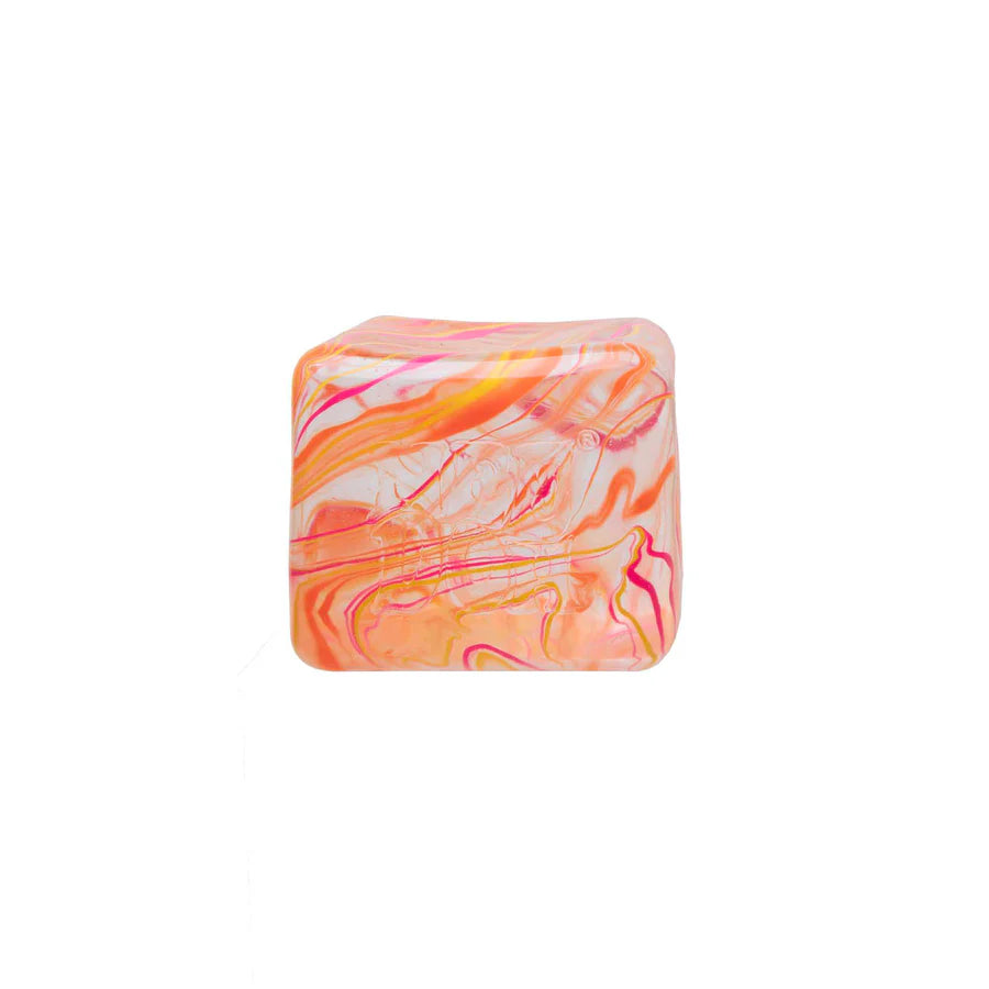 Orange and pink marbled Nee Doh Nice Berg Swirl squish cube on white background showing swirl pattern detail