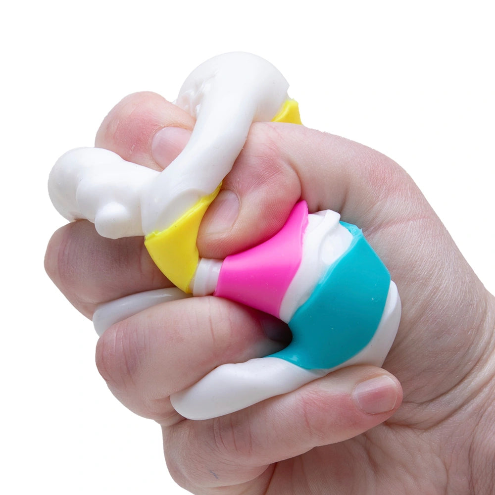 Nee Doh Peace O' Cake squishy sensory toy squeezed in hand, stress relief fidget