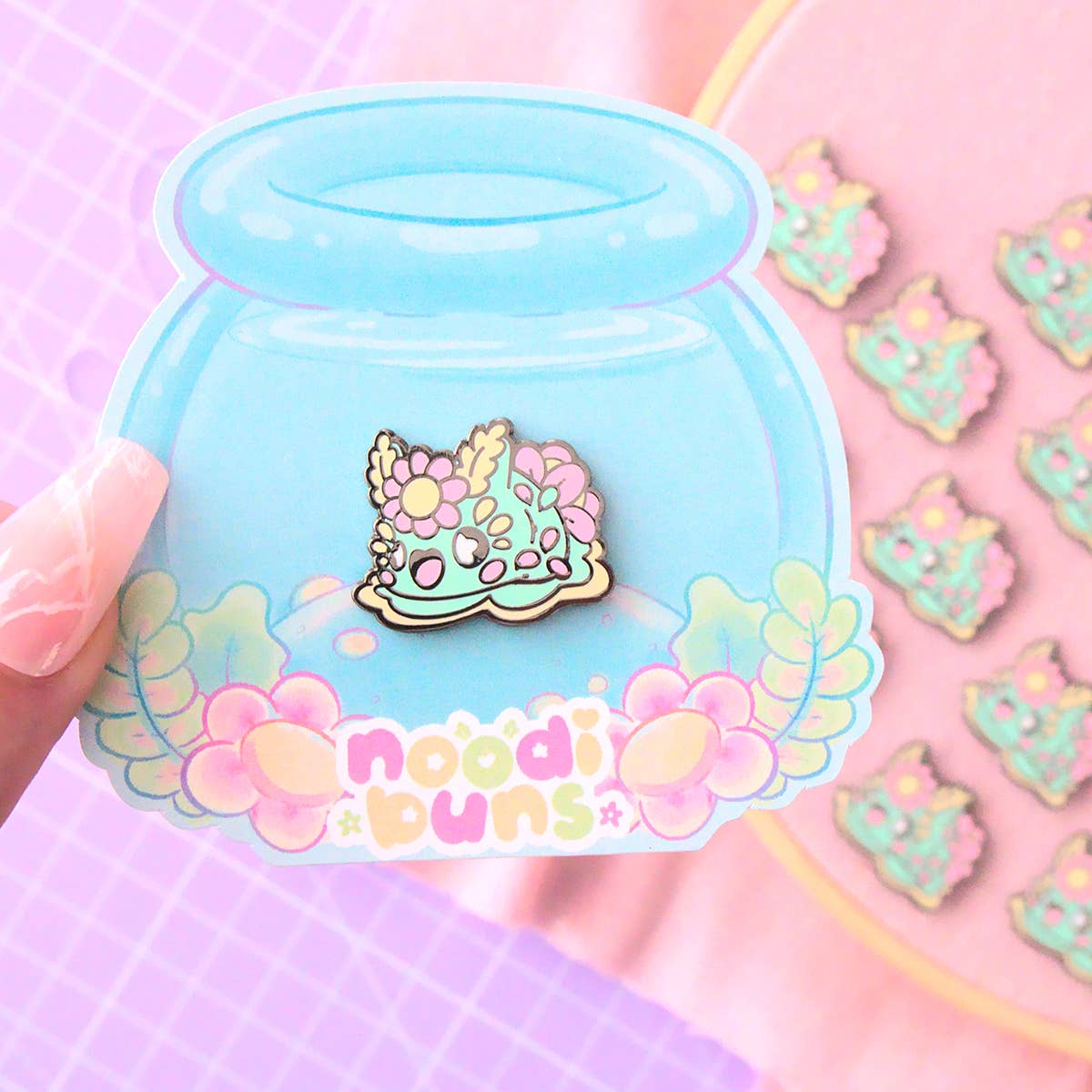 Noodibuns by Evy Benita mint green floral nudibranch kawaii enamel pin, backing card