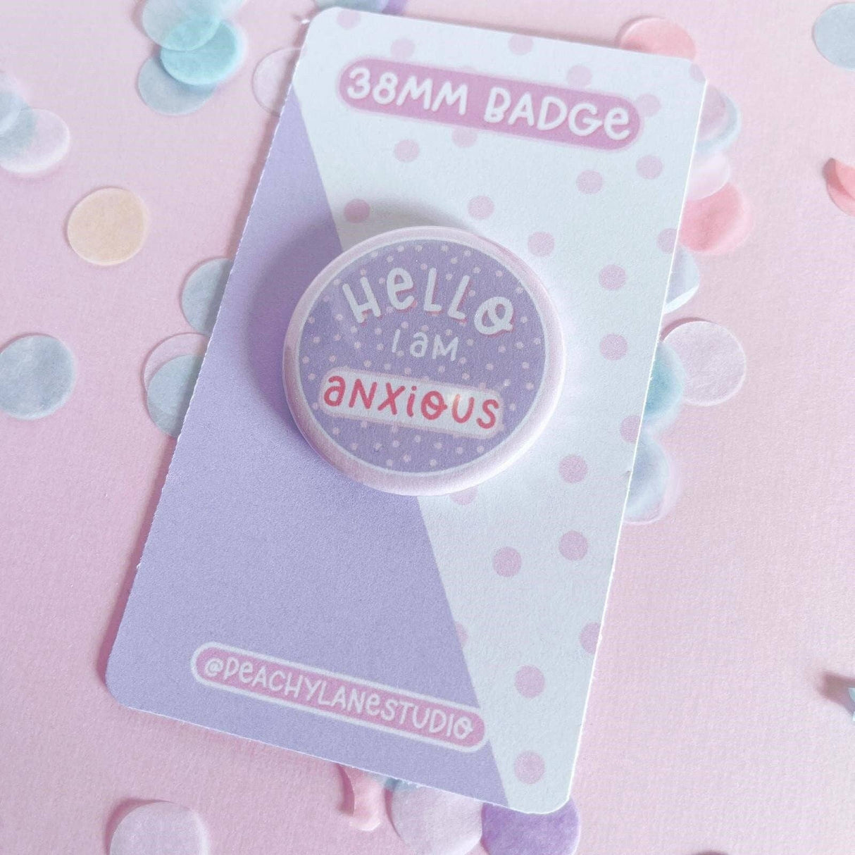 Peachy Lane Studio Hello I Am Anxious 38mm badge, lilac, angled on confetti background