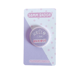 Peachy Lane Studio Hello I Am Anxious 38mm badge, lilac, on white backing card