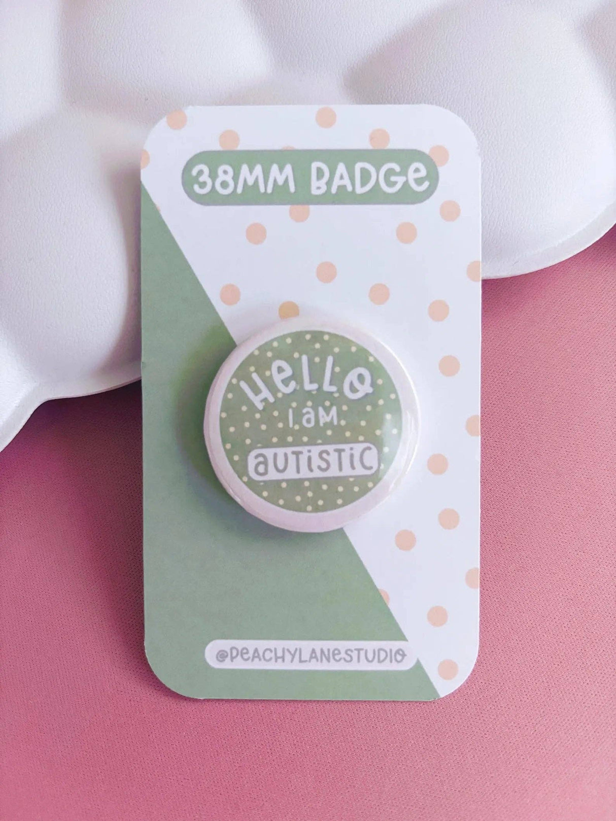 Peachy Lane Studio Hello I Am Autistic 38mm badge, sage green, clean pink background