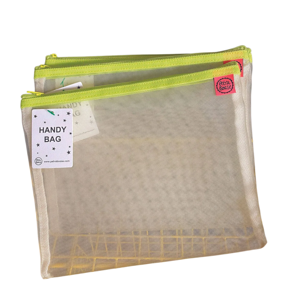 Petra Boase pale mesh handy bag with lime yellow zip shown against white background with Handy Bag tag