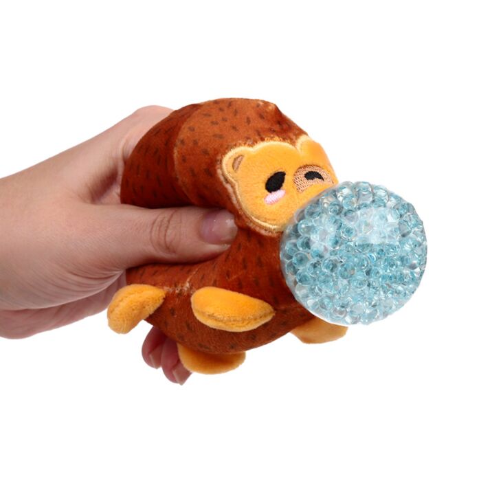 Hand squeezing a brown plush hedgehog Queasy Squeezie causing blue water bead nose to bulge out