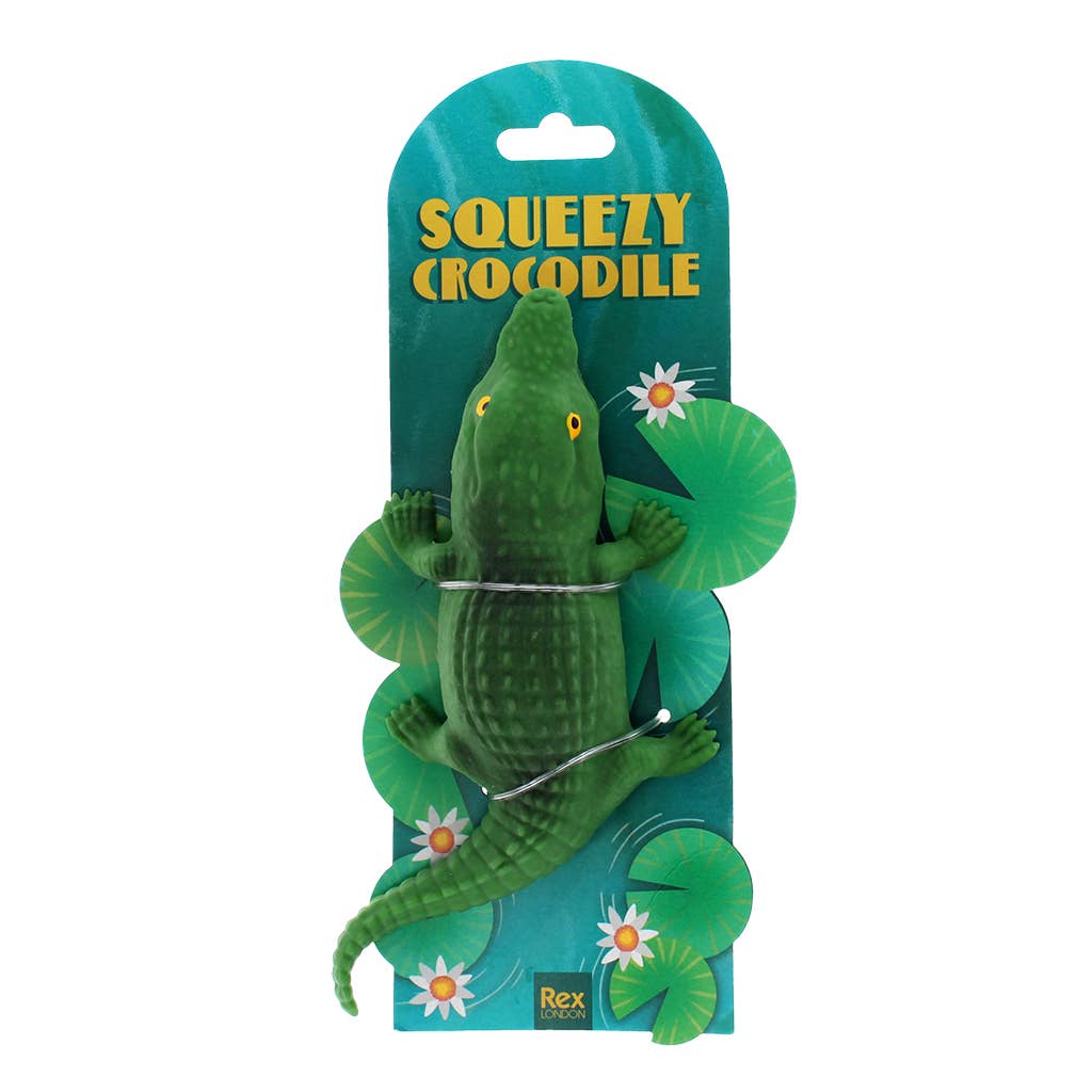 Green crocodile toy with packaging labeled 'Squeezy Crocodile' on a white background