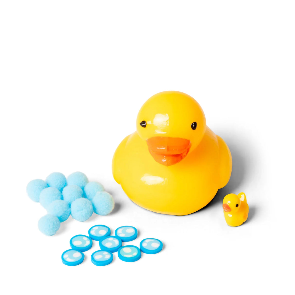 Yellow Scrunchems squishy duck displayed with separated blue pom-pom balls, bubble disc accessories, and mini duckling figure