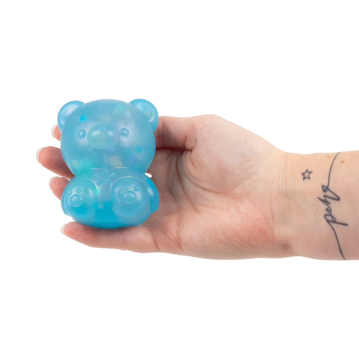 Blue Scrunchems Kind Heart Squish Bear being held in a tattooed hand showing size